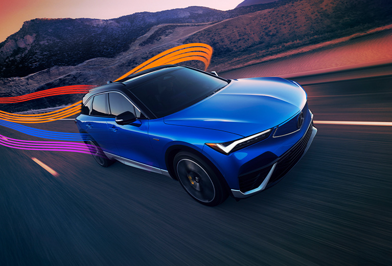 ZDX Type S in Double Apex Blue Pearl driving on a highway with color light streaks
