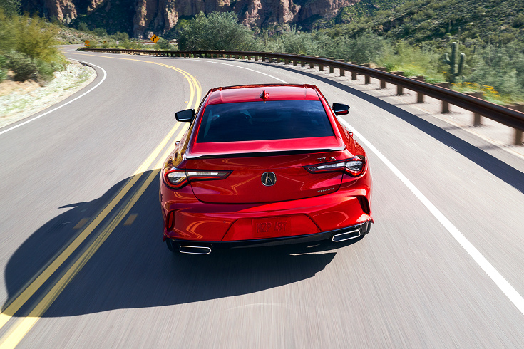 2020 Acura TLX A-Spec in Performance Red Pearl back driving away on a winding desert road (Premium Sport Sedan).