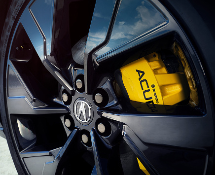 Close up shot of the wheel and yellow brakes.
