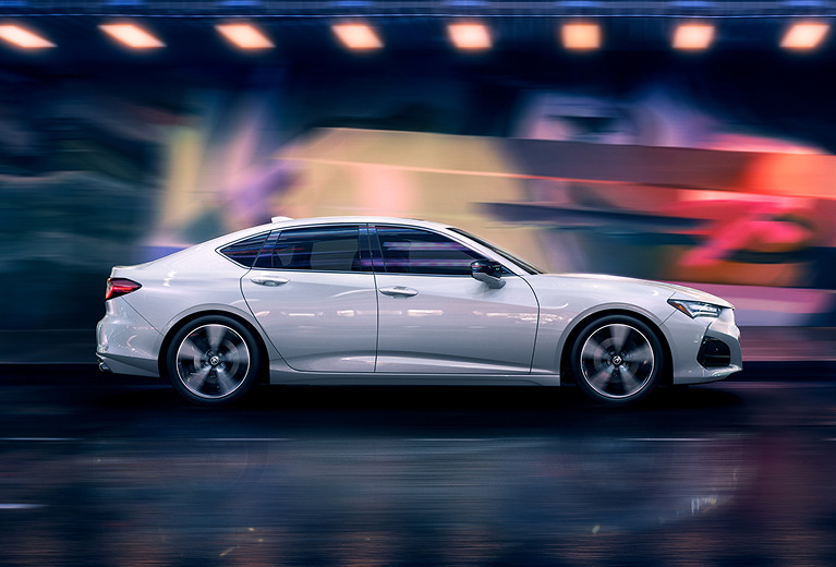 2021 Acura TLX Driving in front of a Colorful wall at night