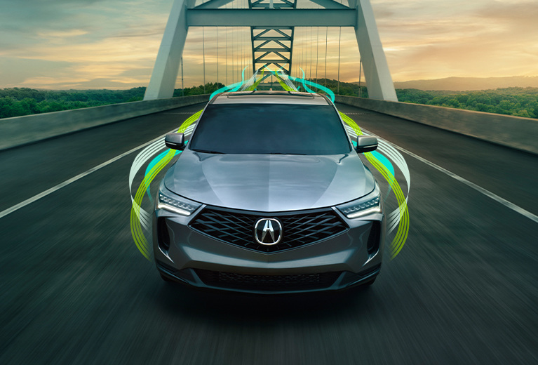 RDX SH-AWD in Liquid Carbon Metallic driving on a bridge with green light streaks