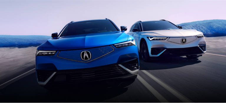 The Acura ZDX type S in blue and another in white racing side by side down a road