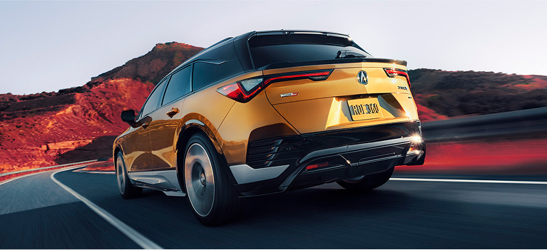 ZDX driving in down a higway in Tiger Eye Pearl