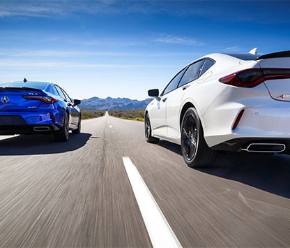 a blue and white 2022 TLX on the road