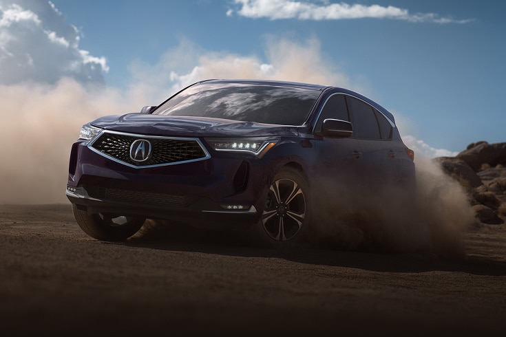 2024 Acura RDX Advance Package in Phantom Violet Pearl front driving on a dusty dirt road (Premium Sport Crossover SUV).